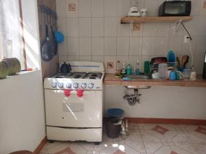 a small kitchen with a stove and a sink at Casa Corozo in Bacalar