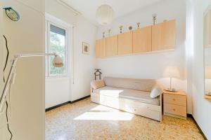 a living room with a couch and a window at Casa Patrizia by PortofinoVacanze in Rapallo