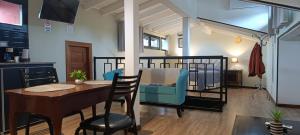 a living room with a table and a bed in a room at ARWEN Suites 2 in Trevelín