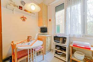 a small kitchen with a table and a microwave at Casa Patrizia by PortofinoVacanze in Rapallo