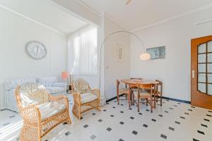 a living room with a table and chairs and a couch at Casa Patrizia by PortofinoVacanze in Rapallo