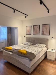 a bedroom with a large bed with yellow pillows on it at Residence Stina in Široki Brijeg +54 photos