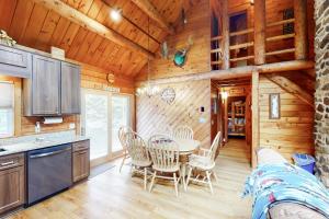 a kitchen and dining room with a table and chairs at Wooded Family Retreat! 11 Mi to Acadia Entrance in Trenton