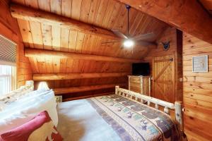 a bedroom with a bed in a log cabin at Wooded Family Retreat! 11 Mi to Acadia Entrance in Trenton