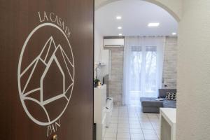 a kitchen and a living room with a couch at La Casa di Pan in Cremeno