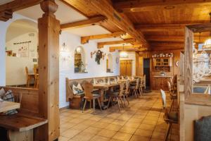 a dining room with a long table and chairs at Jausenstation Pfefferbauer in Zell am See +47 photos