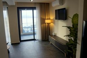 a hotel room with a hallway with a large window at SABBAL apartments in Salamina