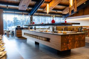 a large kitchen with a counter in a restaurant at Banff Park Lodge in Banff