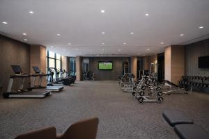 a gym with a row of treadmills and machines at Azha Alriyadh in Riyadh