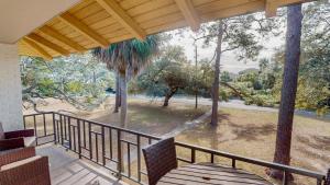 a balcony with chairs and a view of a park at Atlantic Breeze #5 in Jekyll Island