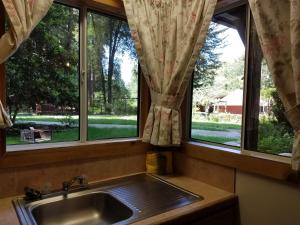 a sink in a kitchen with two windows at Fern River Resort in Felton +287 photos