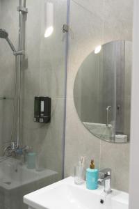 a bathroom with a shower and a sink and a mirror at Мегаполис in Astana +20 photos