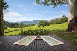 a pool on a deck with a view of a field at Cabana estilo Glamping com Banheiras Quente e Vista às Montanhas in Rio do Sul