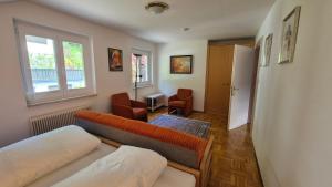 a living room with a couch and a window at Haus Kraller-Urlaub mit Seeblick in Millstatt