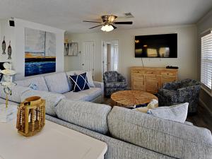 a living room with a couch and two chairs at Bets Kept Secret in Fort Morgan