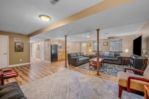 a living room with couches and a tv at Creekview Cabin - Hot Tub, EV Station, Pet Friendly, Screen Porch, Wifi, Grill, Fire Pit, Deck, Family Friendly, Game Room, King Bed in Morton Grove
