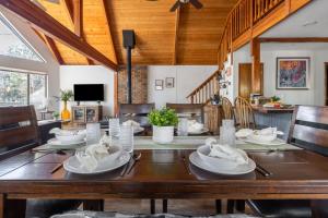 a dining room with a table with white dishes on it at Cozy Chalet in the Pines in Munds Park