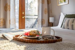 a tray with a plate of food on a bed at Cozy Chalet in the Pines in Munds Park