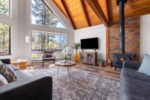 a living room with a fireplace and a tv at Cozy Chalet in the Pines in Munds Park +54 photos