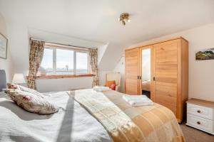 a bedroom with a large bed and a window at 2 Bed in Duns oc-c34024 in Duns