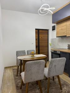 a kitchen with a wooden table and chairs at Apartman Djurdja in Raška