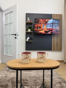 two tea cups sitting on a table in a room at Apartman Djurdja in Raška