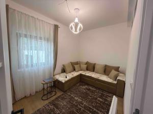 a small living room with a couch and a window at Apartman Djurdja in Raška