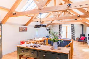 a kitchen and living room with wooden ceilings at 3 Bed in Loddiswell oc-t34185 in Churchstow +21 photos