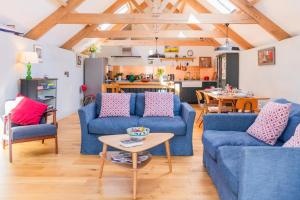 a living room with blue couches and a table at 3 Bed in Loddiswell oc-t34185 in Churchstow