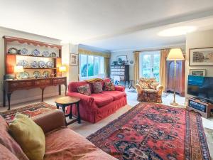 a living room with a red couch and a tv at 4 Bed in Lower Bockhampton oc-t34129 in West Stafford
