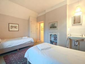 a bedroom with two beds and a sink at 4 Bed in Lower Bockhampton oc-t34129 in West Stafford