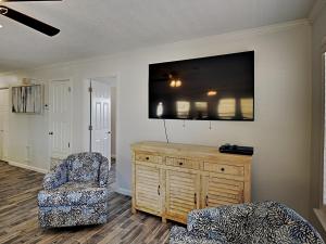 a living room with a tv and a chair at Bets Kept Secret in Fort Morgan +23 photos