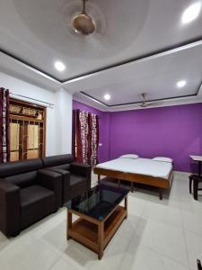 a living room with a couch and a table at Hotel New Castle in Guwahati +13 photos