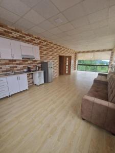 an empty room with a couch and a kitchen at Brick Villas in Qusar +10 photos