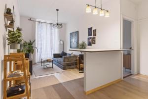 a kitchen and living room with a large white counter top at Bistro Walk Apartment in Lausanne
