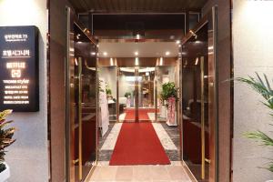 a hallway with a red carpet in front of a building at Hotel Signature Gwangju in Gwangju