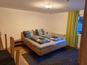 a bedroom with a bed with blue pillows on it at Haus Nilson I klimatisierte Ferienwohnung in Gengenbach +49 photos
