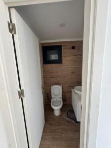 a bathroom with a toilet and a tv on the wall at 3 bed flat in Nicosia in Nicosia
