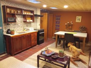 a kitchen with a table and a dining room at Rincon Acogedor in Bogotá
