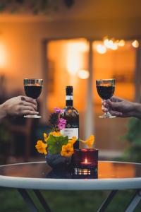 two people holding glasses of wine on a table at Coraline -Koblach, 6-10 P, 3 Schlafzimmer, Küche, riesige Terrasse, Parkplatz, WiFi, Stellplatz Ski in Koblach +45 photos