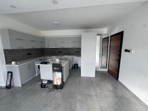 an empty kitchen with white cabinets and a floor at 3 bed flat in Nicosia in Nicosia