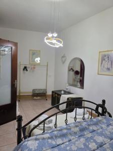 a bedroom with a bed and a mirror at Casa Grilla in Assemini