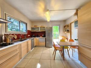 a kitchen with a table and a dining room at Symphony - in Saint-Emilion in Saint-Émilion