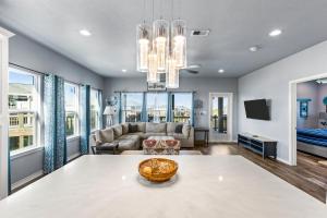 a living room with a table and a couch at Steps to the Beach l Modern Interior in Crystal Beach