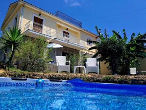 a swimming pool in front of a house at Enjoy The Silence in Svoronata