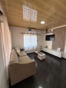 a living room with a couch and a flat screen tv at Casa del parque in Oberá