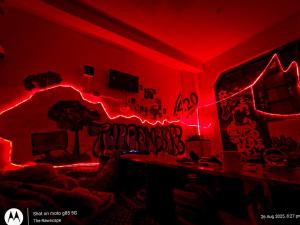 a room with red lights and graffiti on the wall at The Rawscape Hostel in Kausani