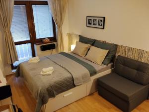 a bedroom with a large bed and a chair at Donovaly Kamzík in Donovaly