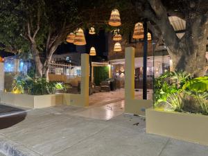 a lobby of a building with plants and lights at Arcadia Hotel in Cartagena de Indias