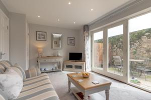 a living room with a couch and a tv at 2 Bed in Beadnell oc-gd0376 in Beadnell